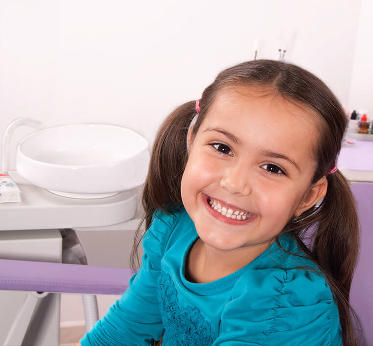 young girl smiling at dentist