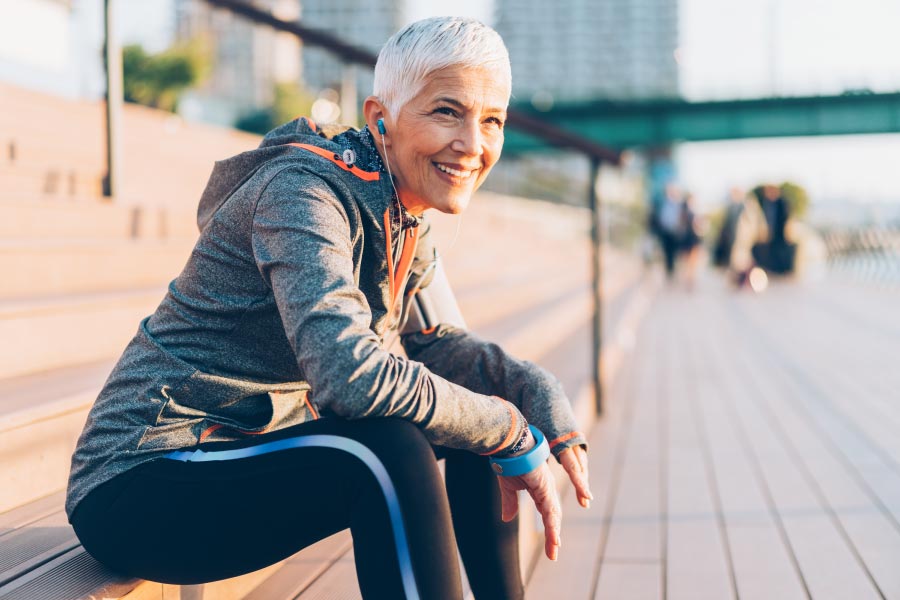 Fit mature woman sitting on the steps after a run.