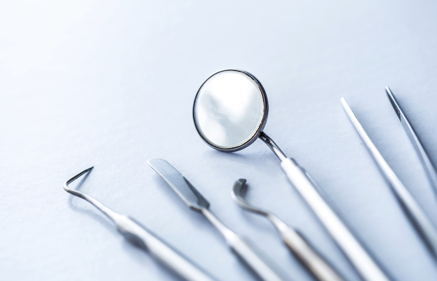 Clean dental tools on a blue surface