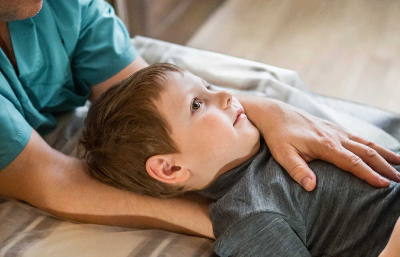 osteopathic doctor manipulating a childs torso