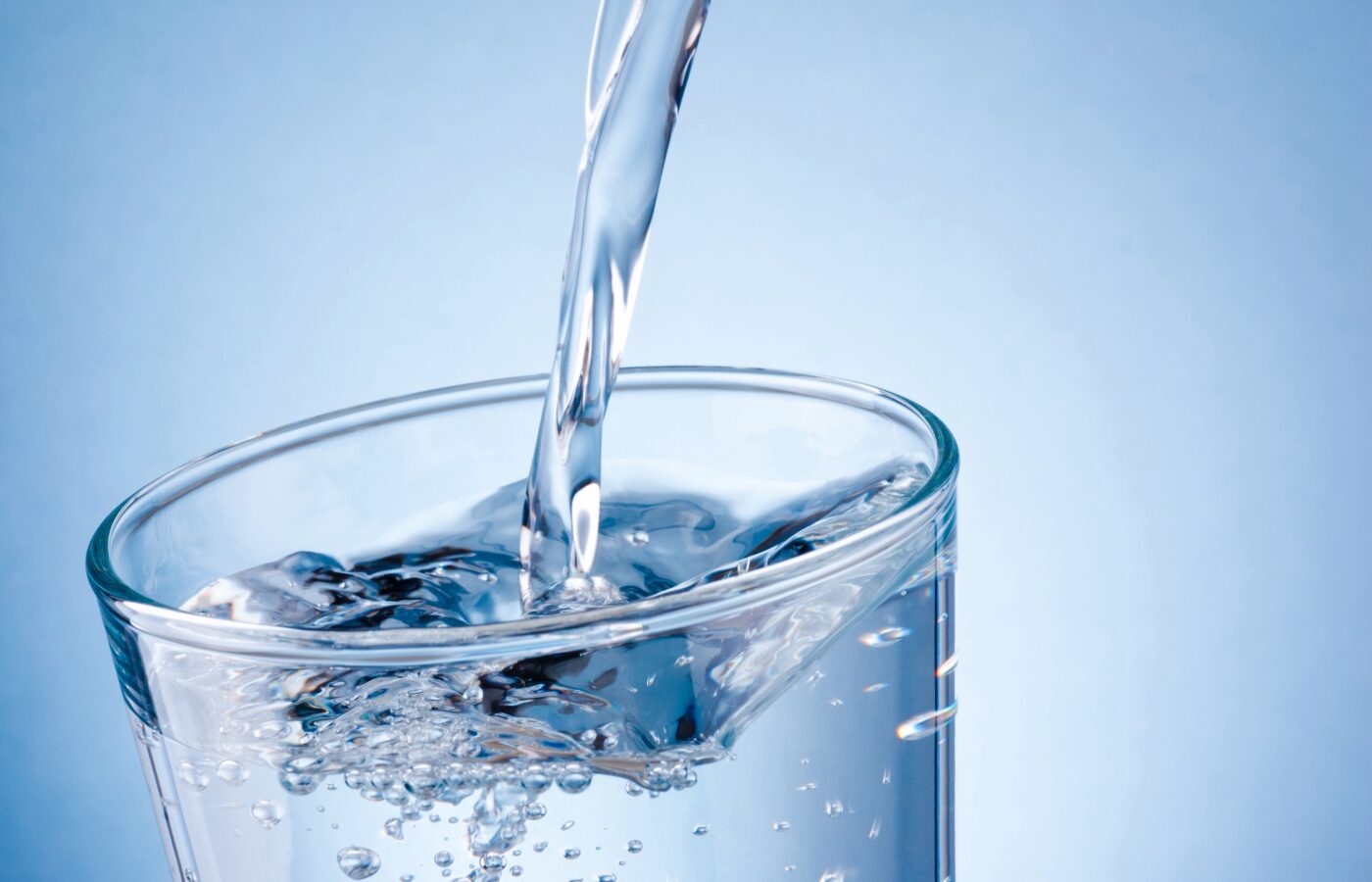 Glass of water against a blue background