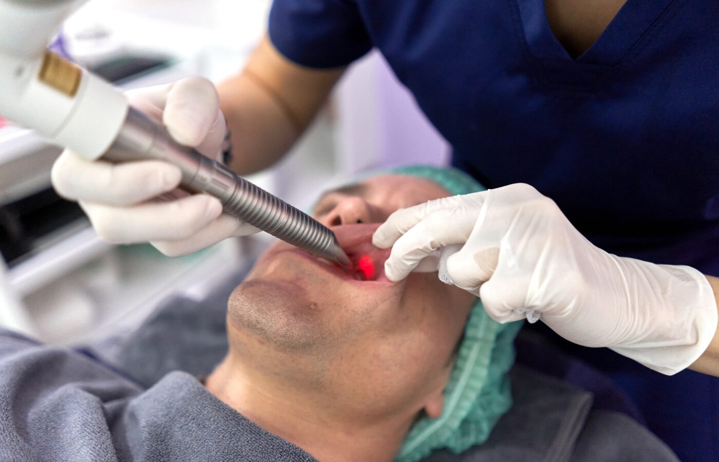 Laser in mans mouth doing a procedure