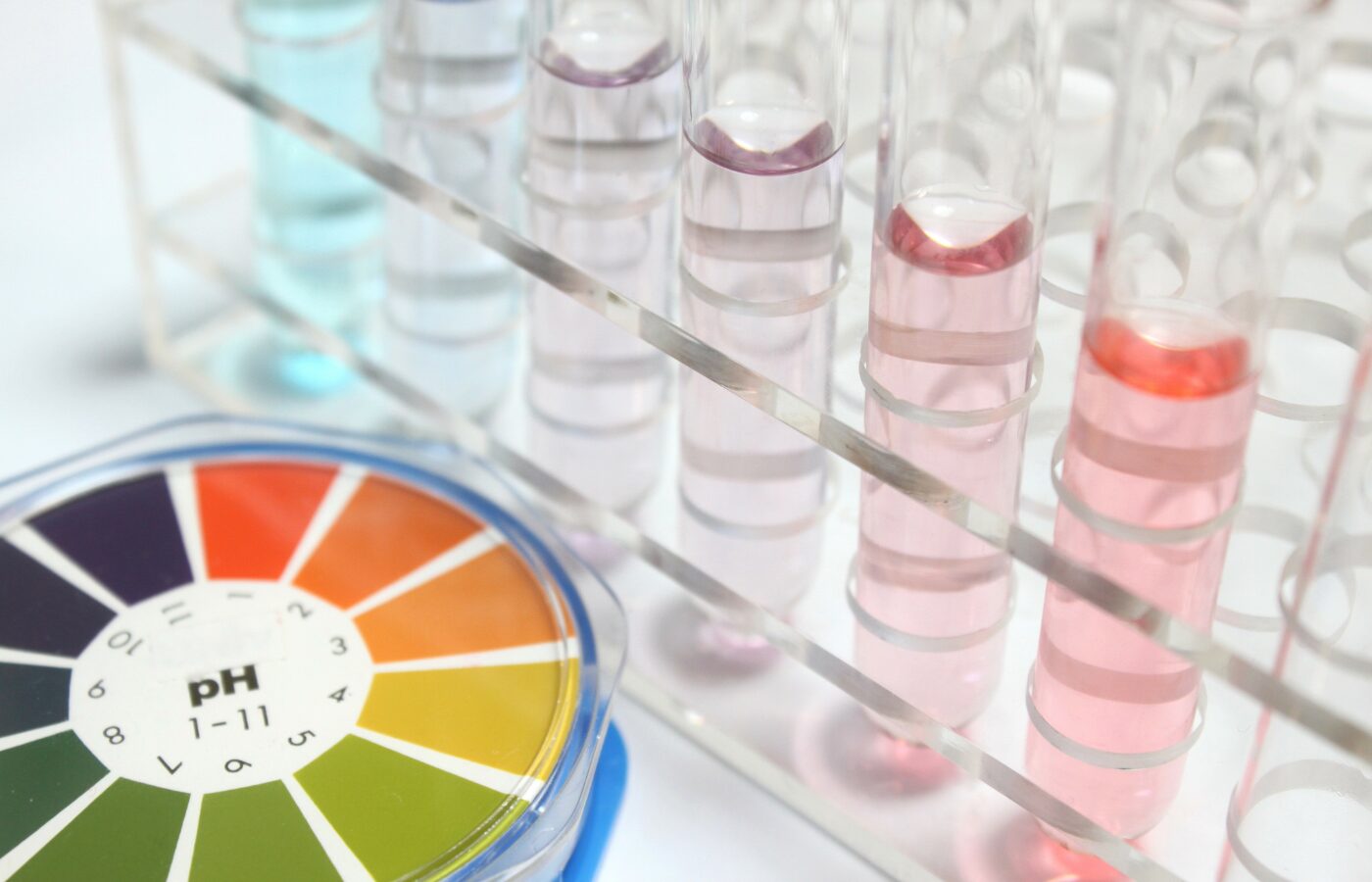 ph wheel to compare with test tubes on white table