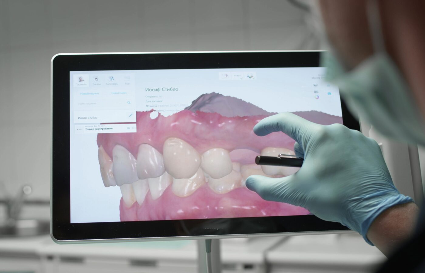 dentist looking at a screen of a scanned reconstructed bite
